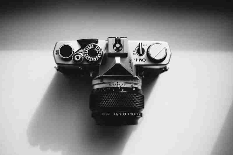 Gray Scale Photography of camera with high shutter speed