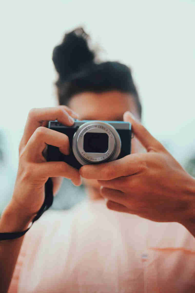 picture girl showing point and shoot camera 