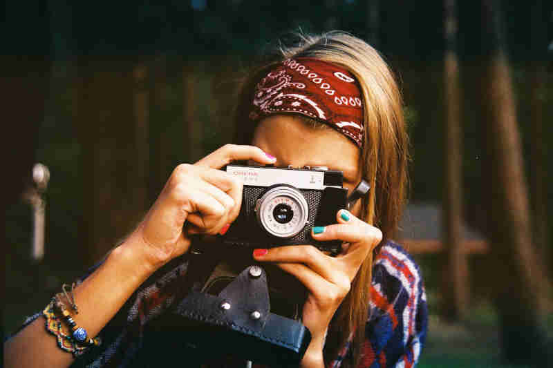 Young Woman Taking Photographs using professional camera